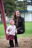 A woman and child on a swing