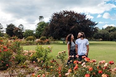 A couple in a park with flowers