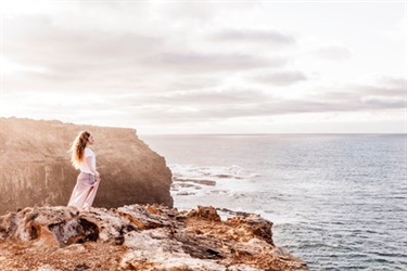 A woman standing on a cliff