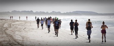 People running a race on a beach