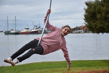 Girl swinging on a seat swing