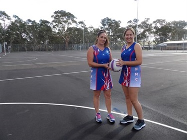Two netball players on a court