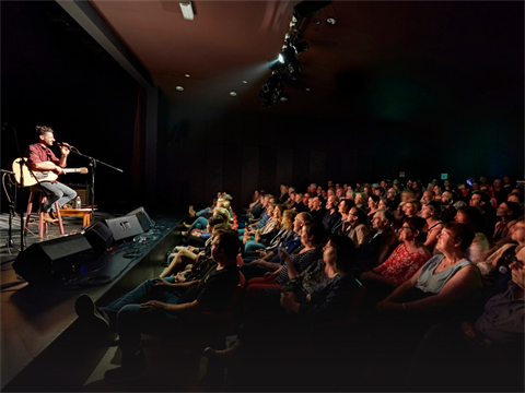 Crowd at Arts Centre listening to Musician