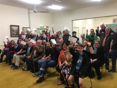 People in a room being awarded grant funds