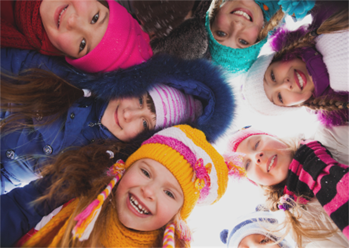 kids in a circle looking down at the camera